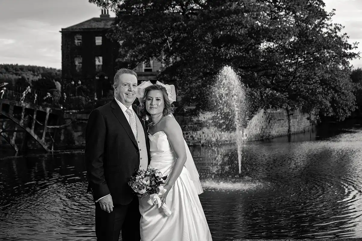 Bride and groom by the lake at Waterton Hall, Wakefield